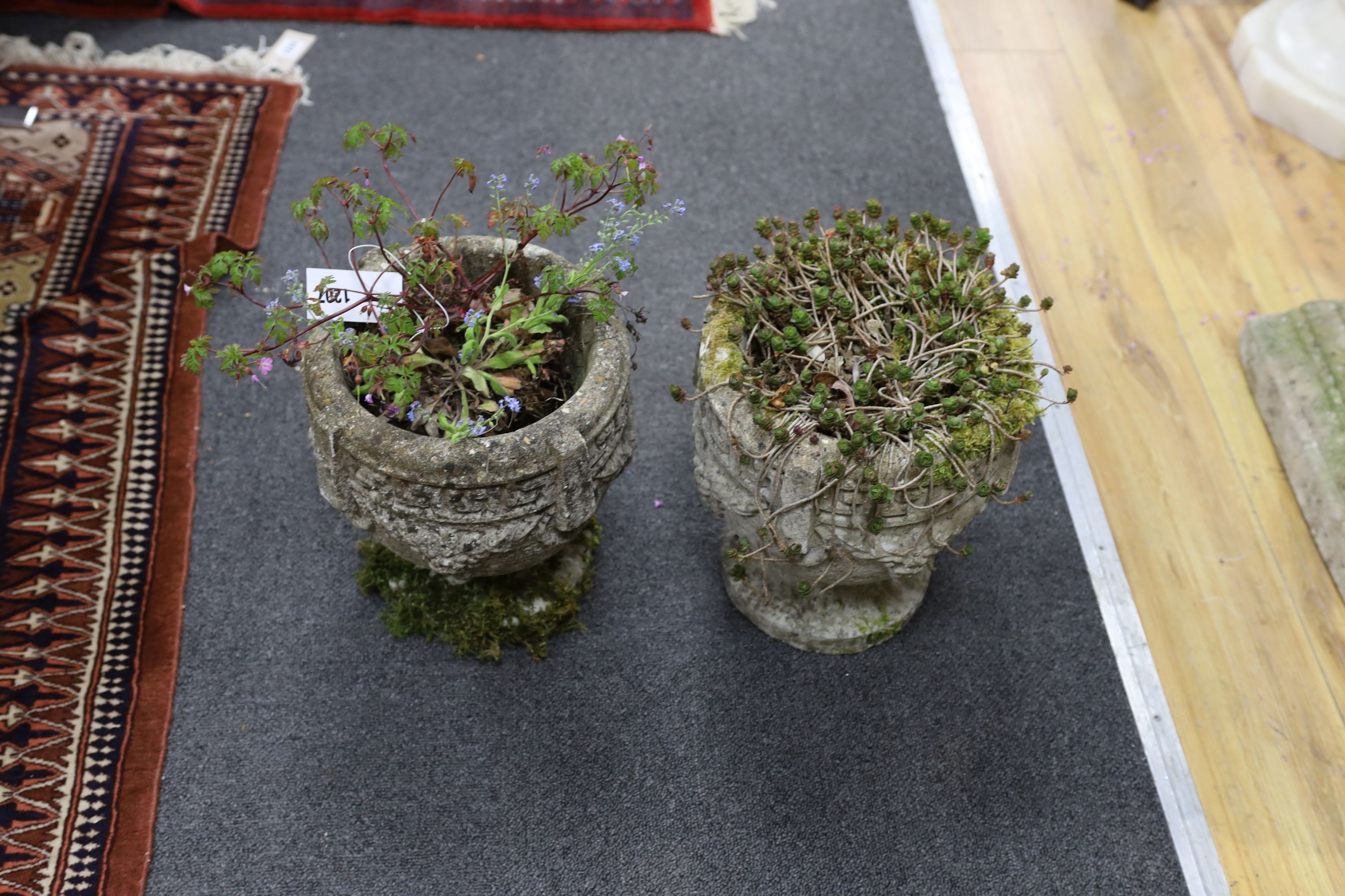 A pair of small reconstituted stone circular garden planters, diameter 23cm, height 28cm